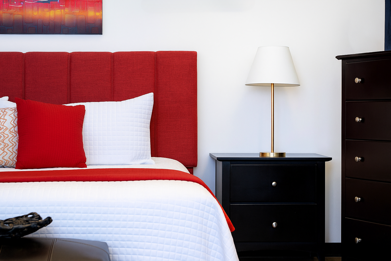 A sample bedroom for the creature of comfort bed, end tables and decorations.