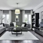 A furnished living room with a gray and black theme.