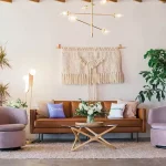 A brown leather couch surrounded by lavender chairs