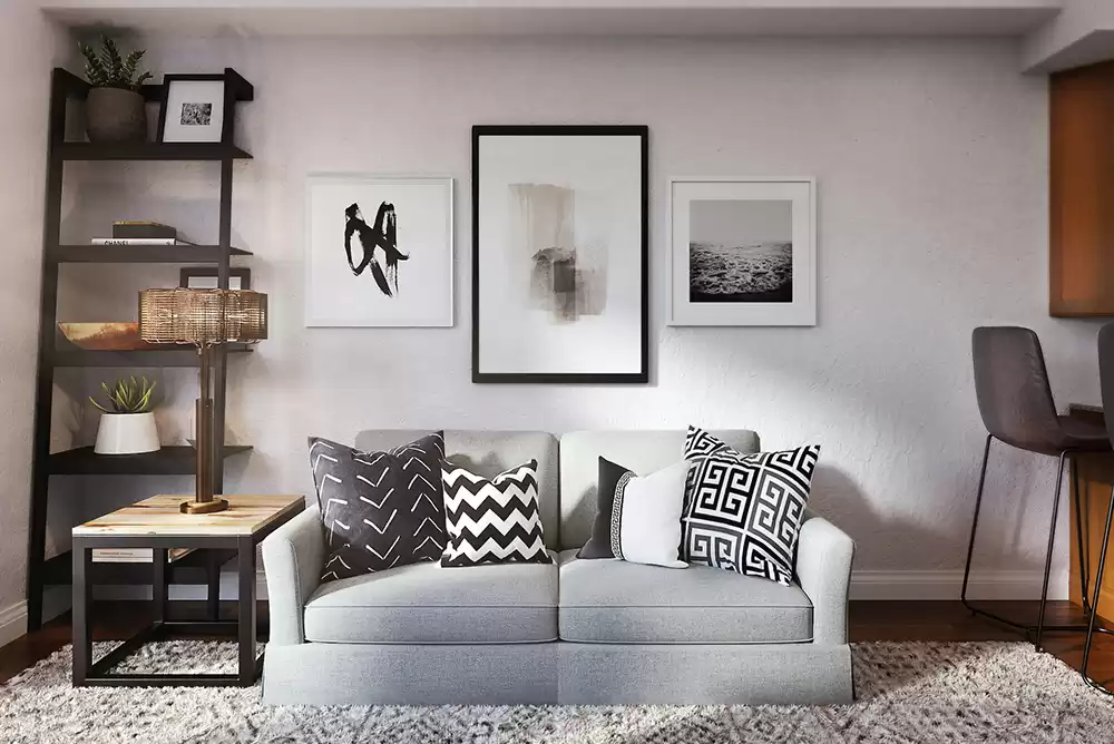 a cozy living room set up with wall decor and rented furniture
