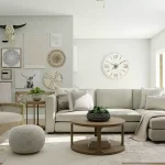 a living space furnished with a white chair, gray couch, brown table, and with decorations on the wall