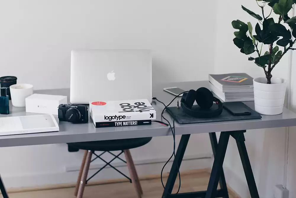 A clean, modern work desk with a laptop.